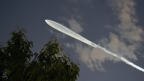 Falcon-9 exhaust trail lit by sunlight